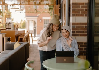 a woman sitting at a table using a laptop