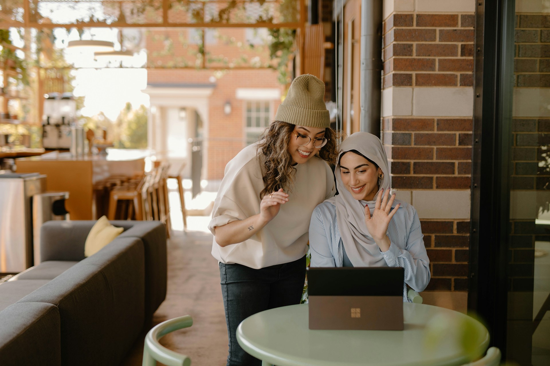 a woman sitting at a table using a laptop