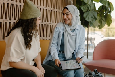 a couple of women sitting on a couch