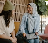 a couple of women sitting on a couch