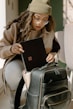 a woman holding a piece of luggage