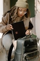 a woman holding a piece of luggage