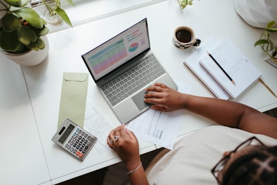 a person sitting at a table with a laptop