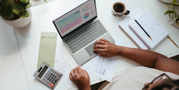 a person sitting at a table with a laptop