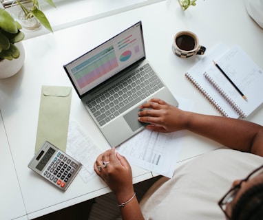 a person sitting at a table with a laptop