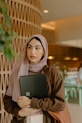 a person holding a laptop