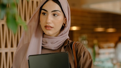 a person holding a laptop