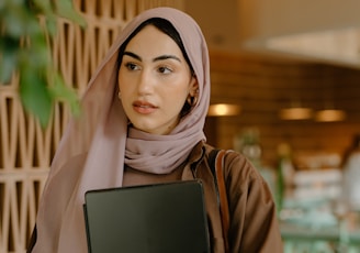 a person holding a laptop