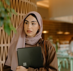 a person holding a laptop