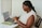 a person sitting at a table using a laptop computer