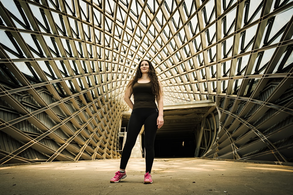 a person posing in front of a large glass ceiling