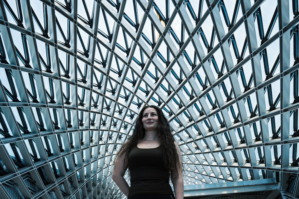 a woman standing in front of a large blue and gold dome