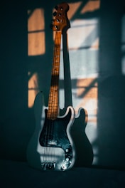 a guitar leaning against a wall