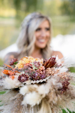 a bride holding boho wedding bouquet