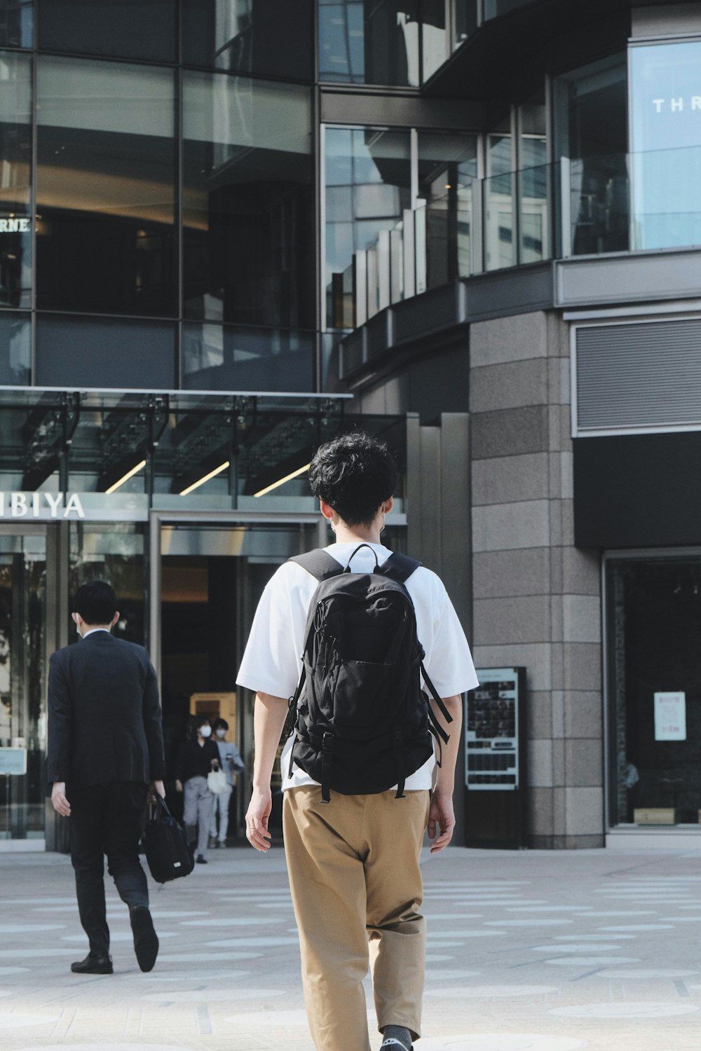 a man walking outside of a building