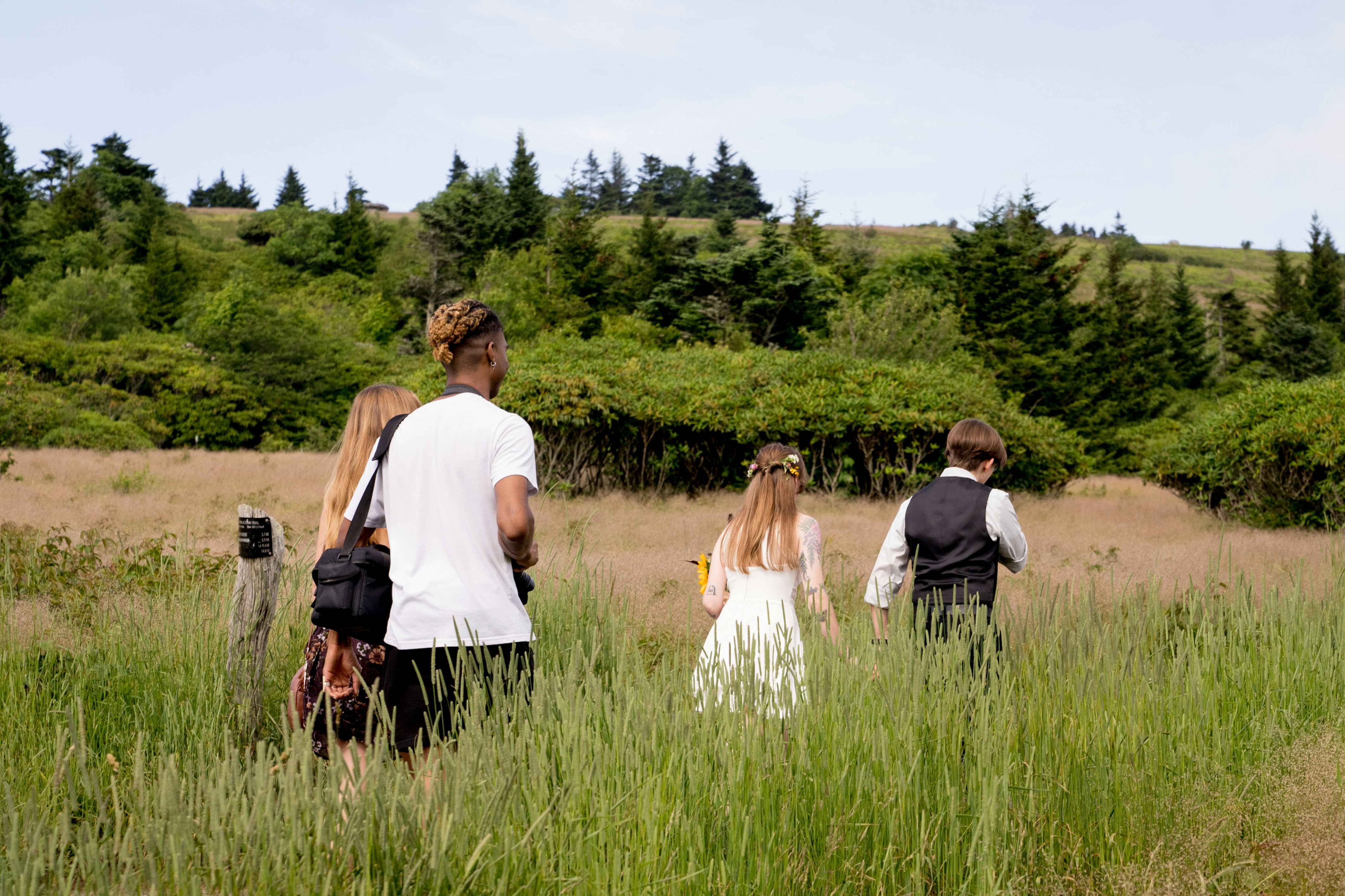 a group of people standing in a field