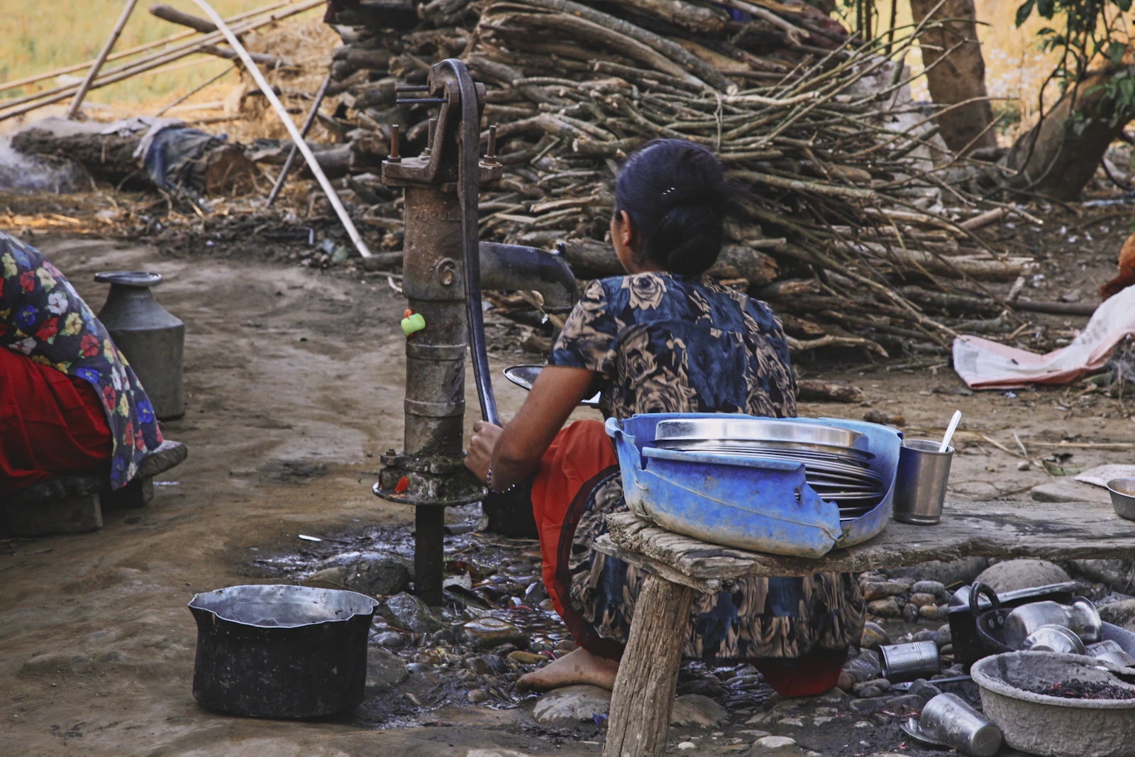 A person cooking outdoors in a Tharu village in the Terai lowlands near Chitwan, Nepal