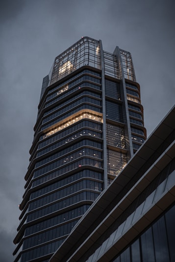 a tall building with many windows with Reichstag dome in the background