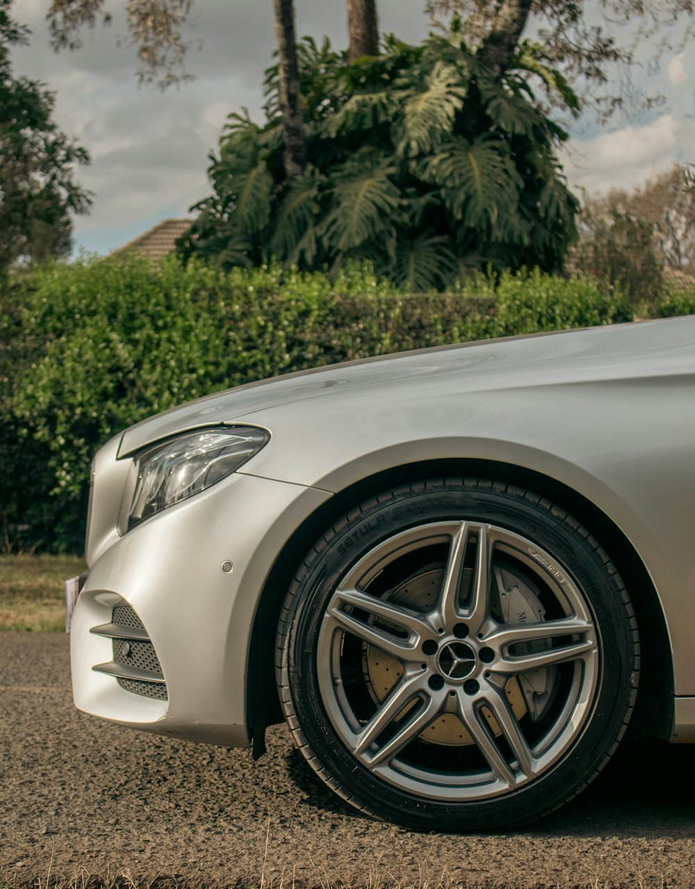 a white car parked on gravel