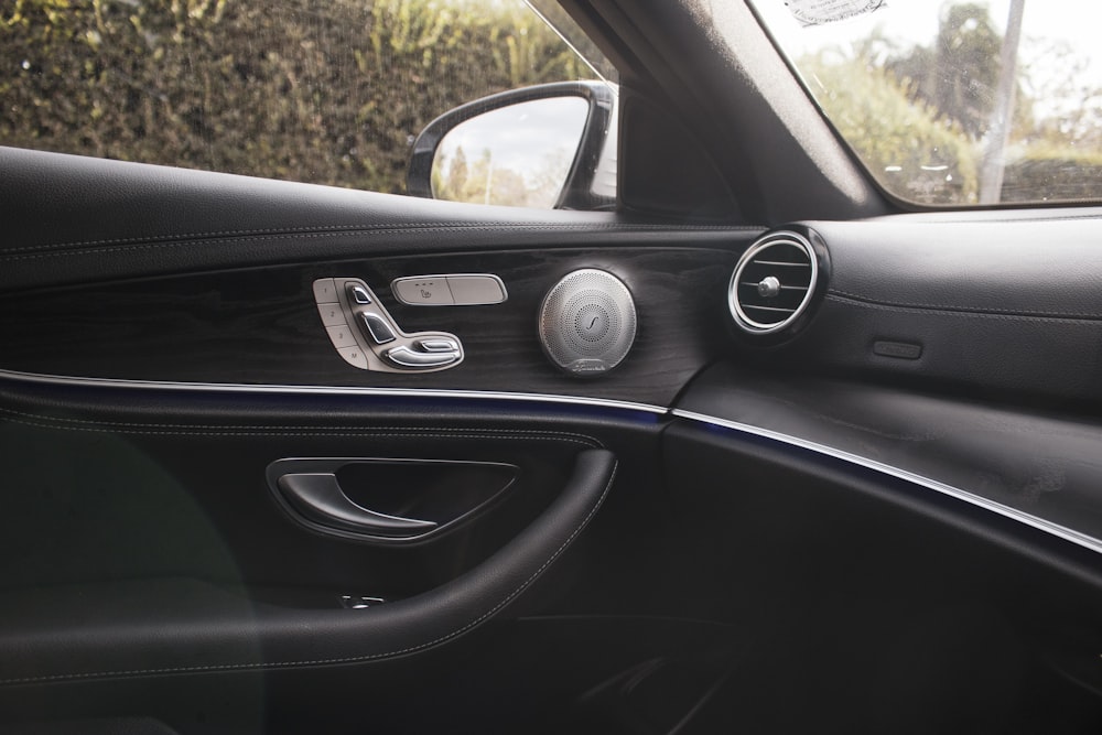 a car dashboard with a couple of round silver knobs