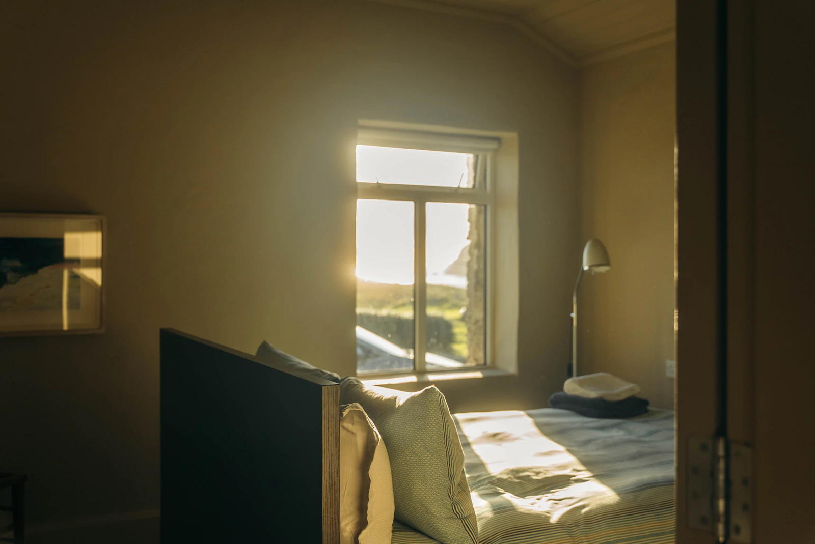 A bedroom with daylight coming through a single window