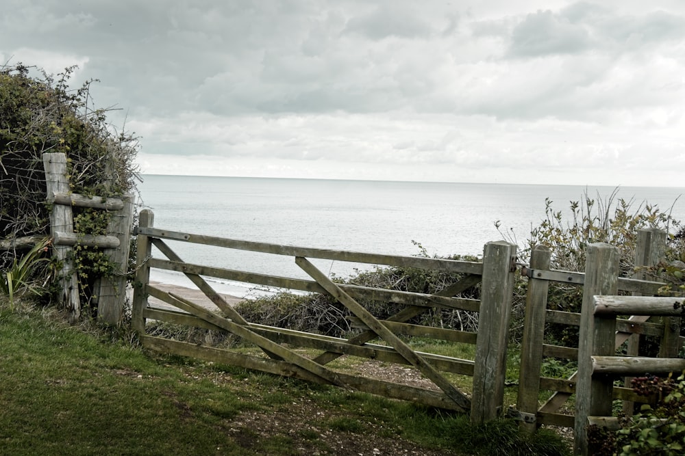 a wooden fence overlooking a body of water