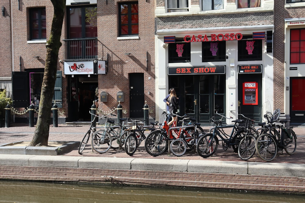 a group of bicycles parked on the side of a street