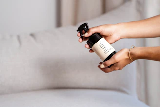 a person holding a bottle