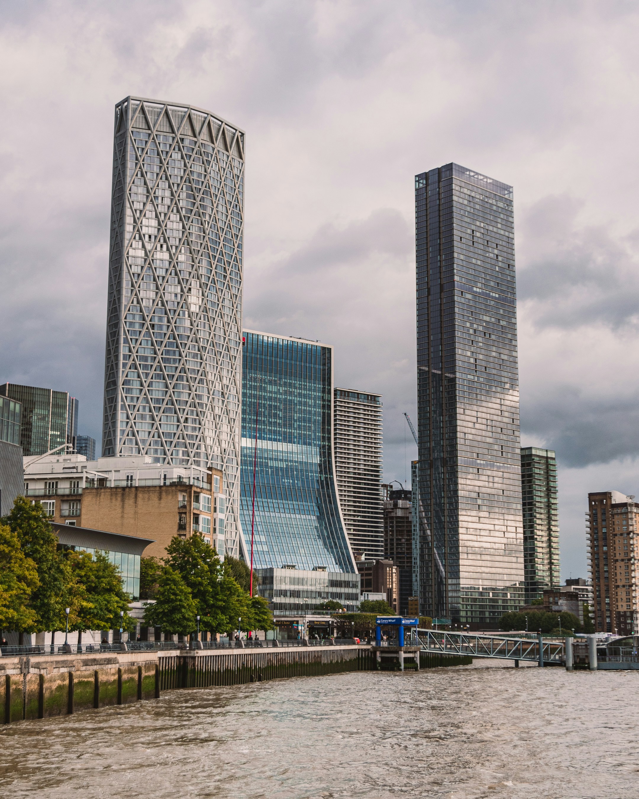 a group of tall buildings by a river