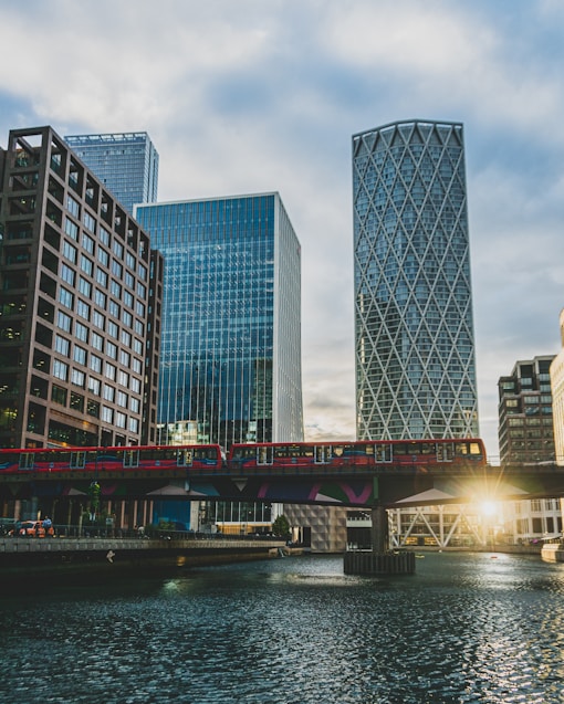 a bridge over a river with tall buildings in the background