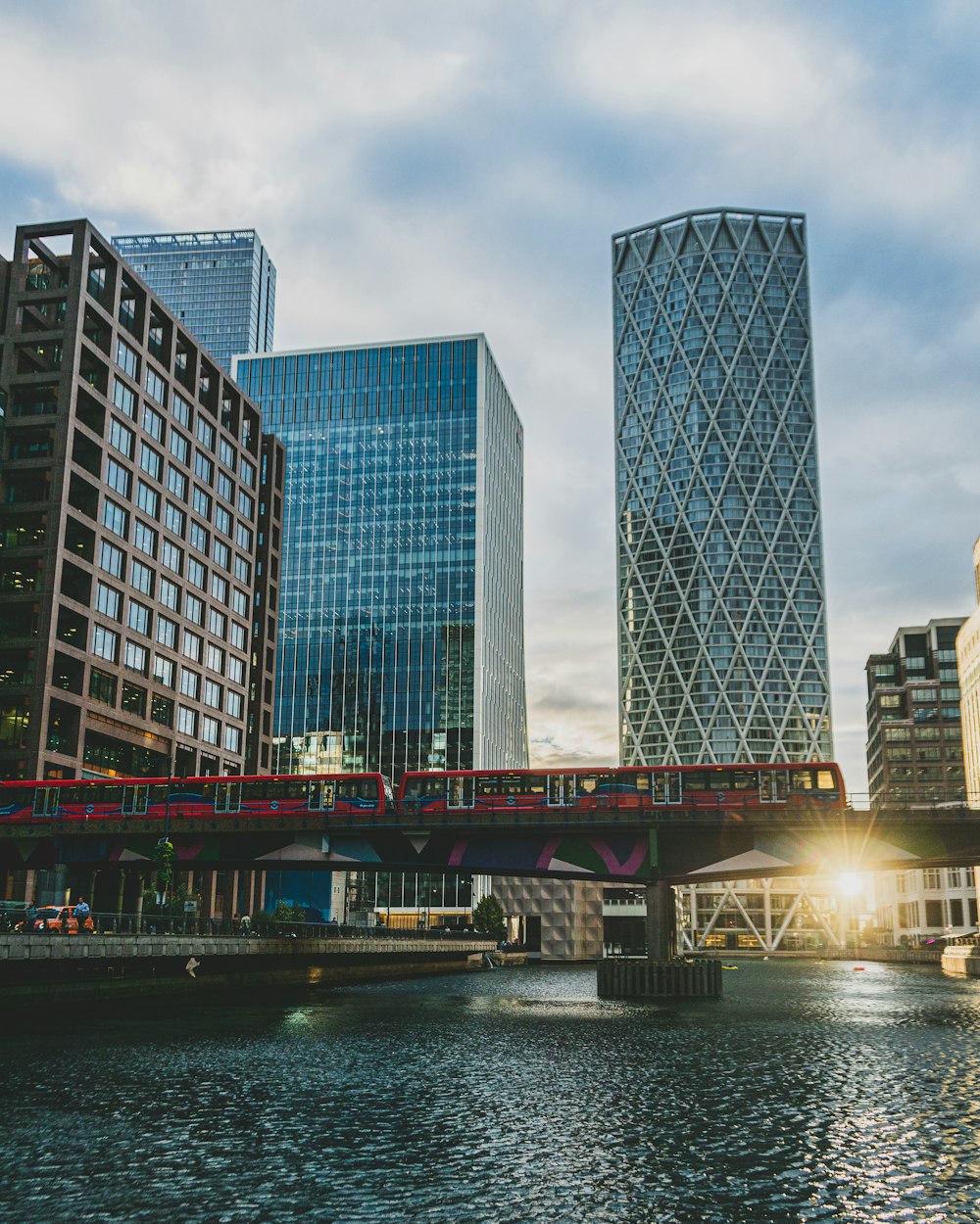 a bridge over a river with tall buildings in the background