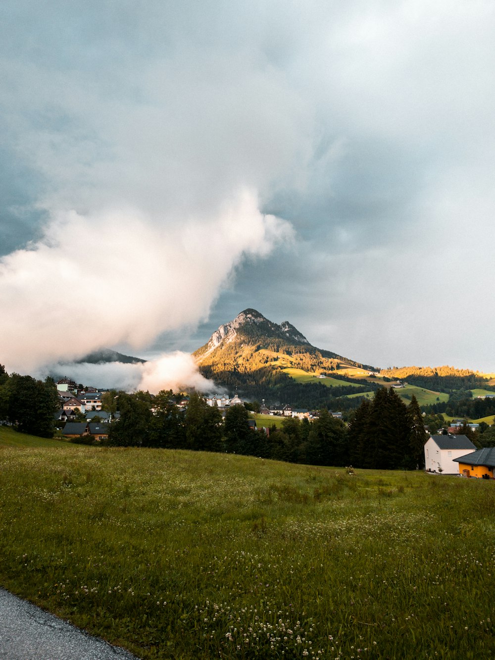 a mountain with clouds above it