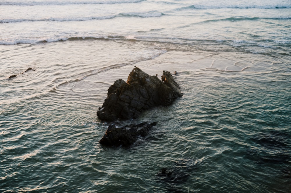 a group of rocks in the water