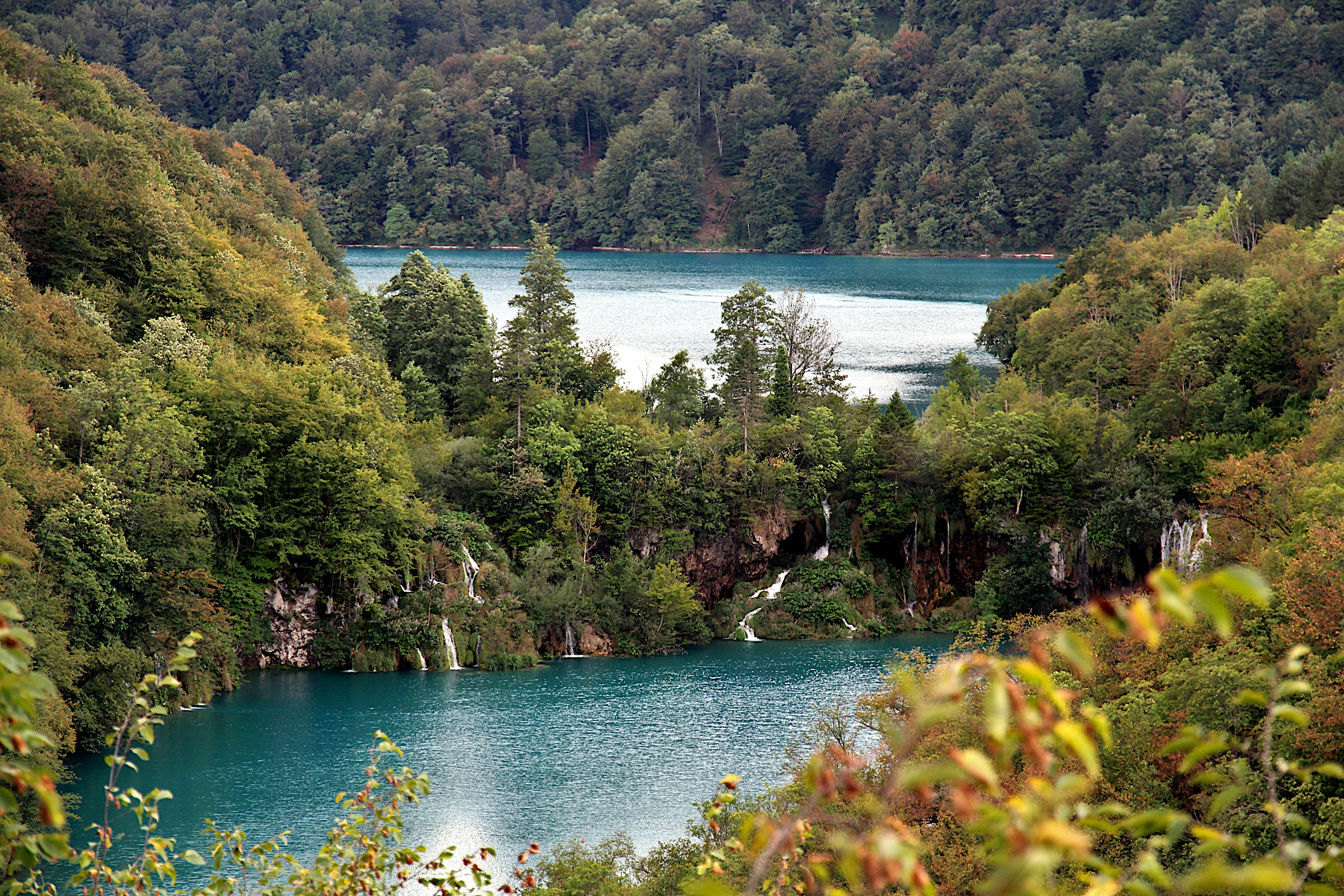 a lake surrounded by trees, Waterfalls between two lower lakes, Plitvice Lakes National Park, Croatia, August 2022