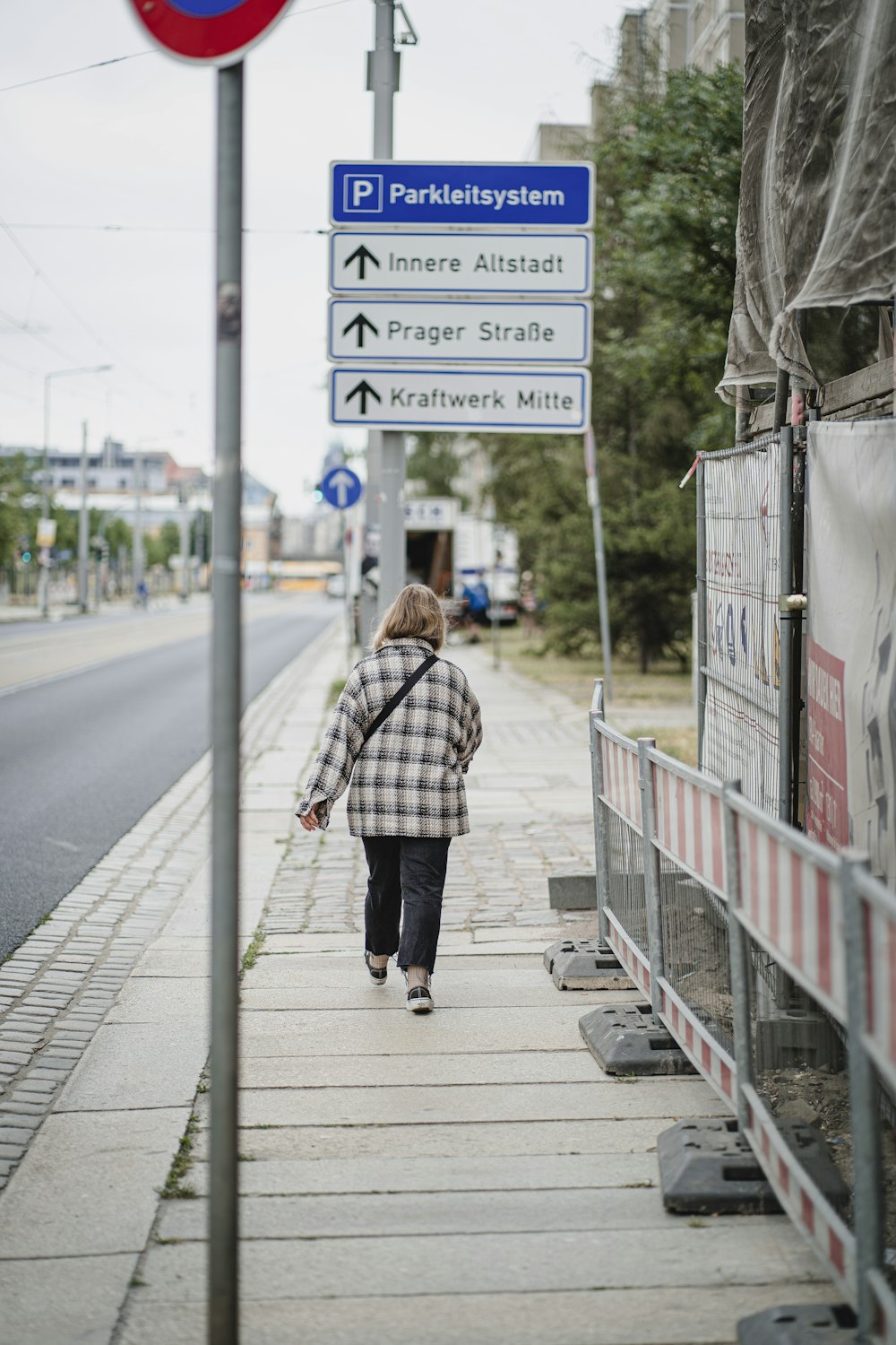 a person walking down a sidewalk