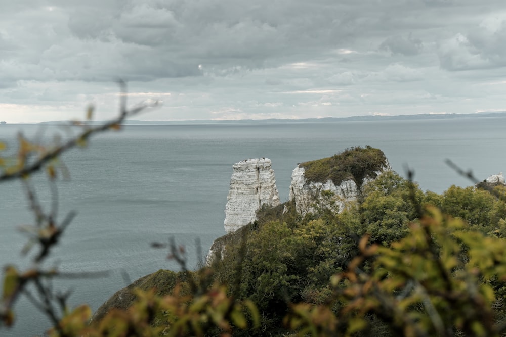 a rocky cliff with a body of water below