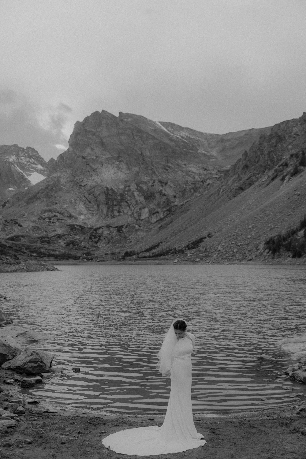 a man standing next to a body of water