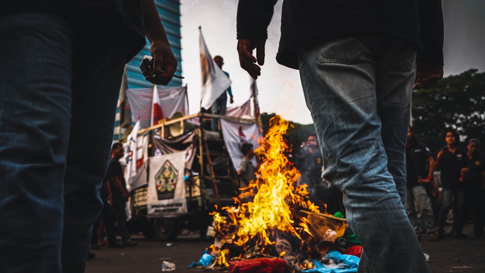 a person standing next to a fire