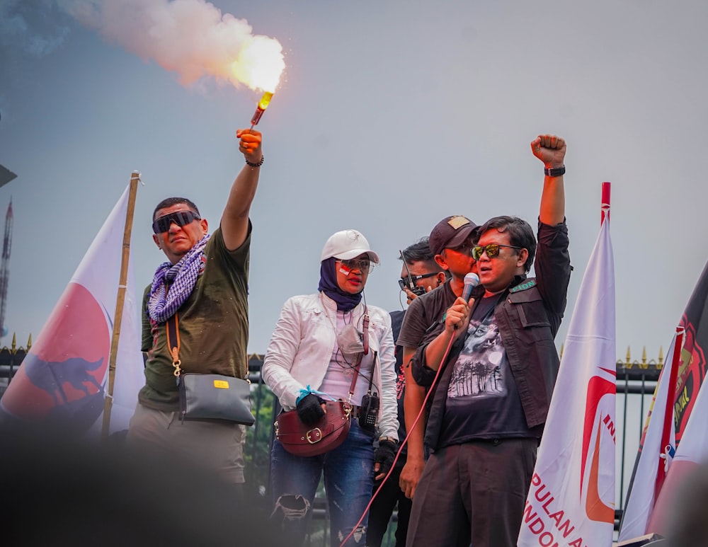 a group of people holding flags