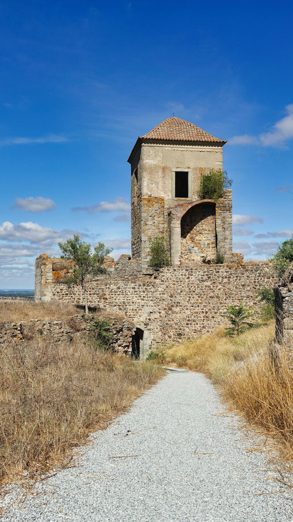 a stone building on a hill