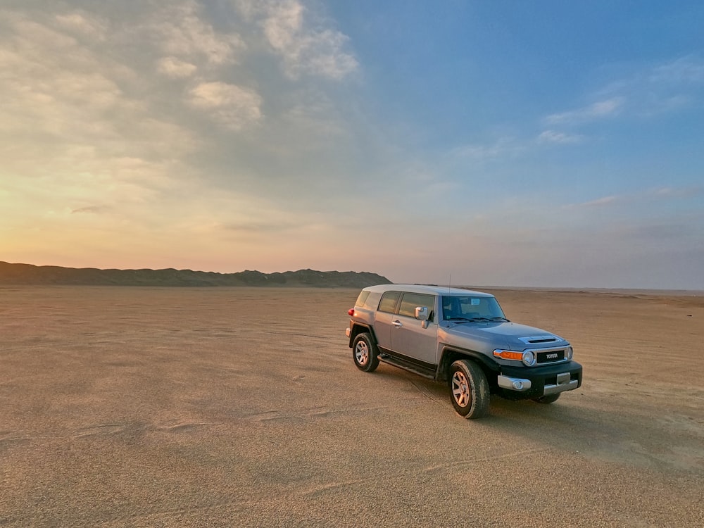 a car parked on a sandy beach