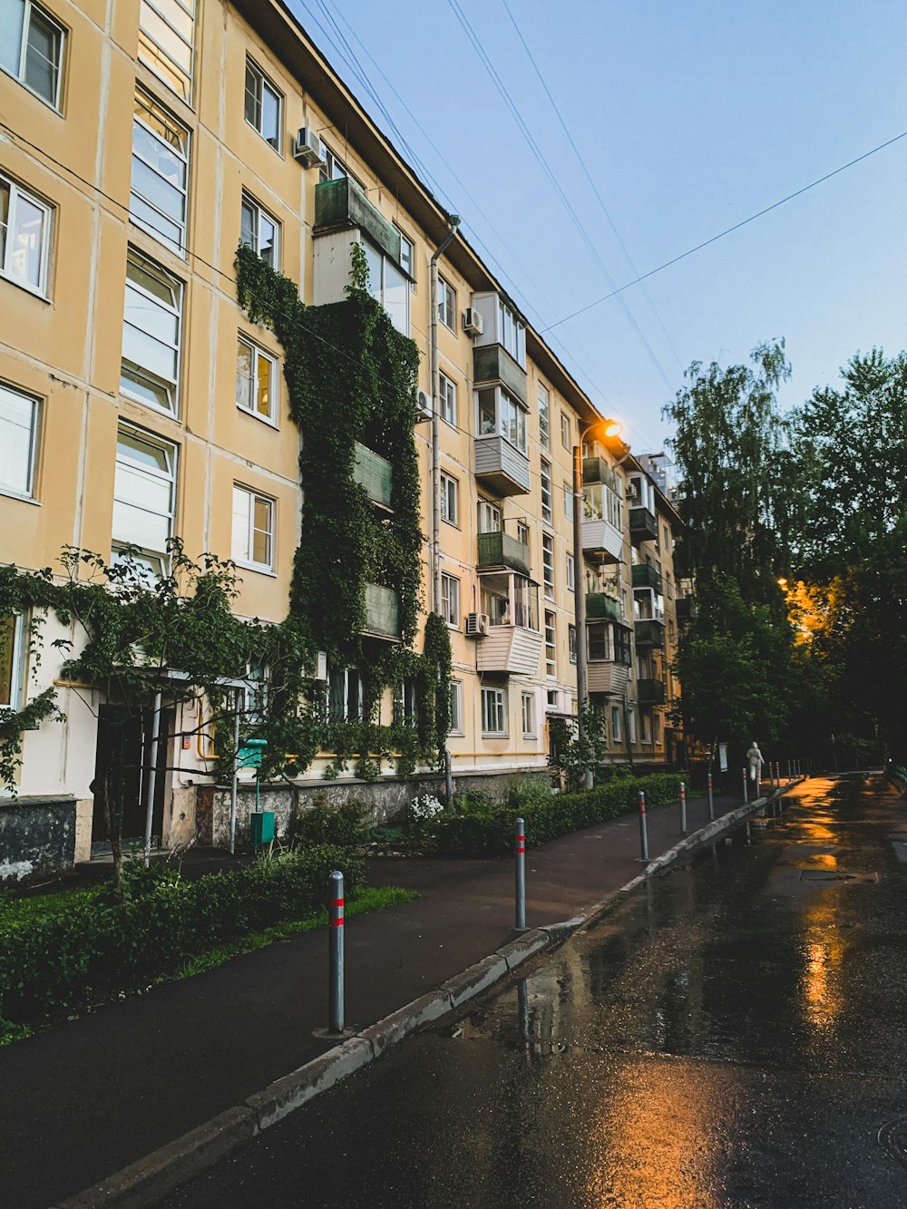 a wet street with buildings on either side of it