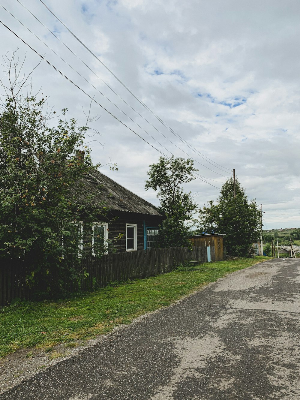 a house with a fence and trees around it