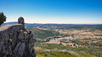 a rock cliff overlooking a valley