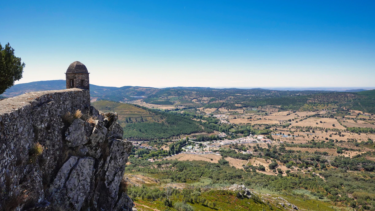 a rock cliff overlooking a valley