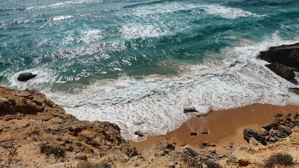 a rocky beach with waves crashing