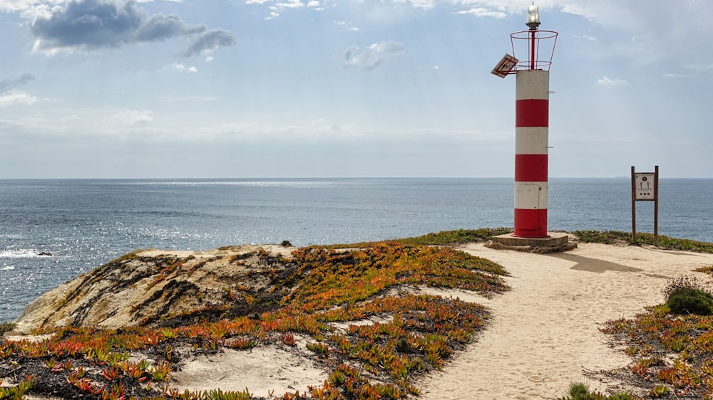 a lighthouse on a rocky beach