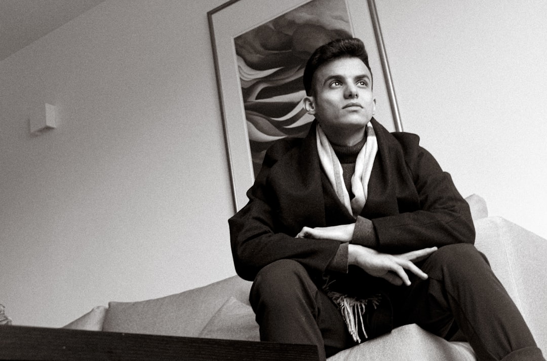 a man sitting on a bed,