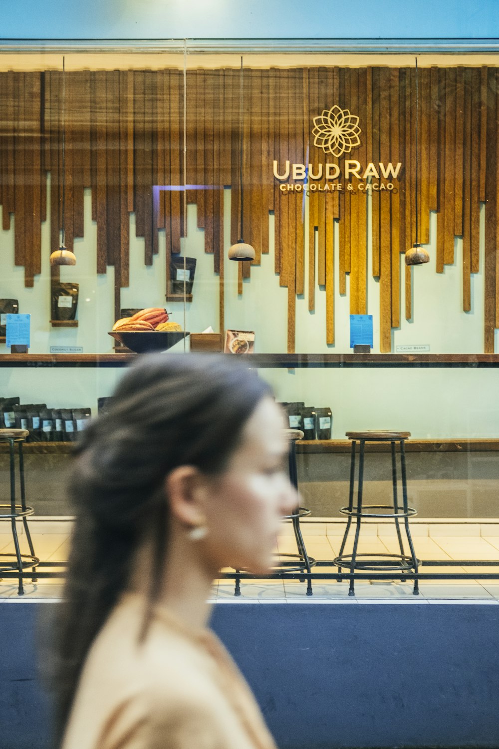 a woman looking at a wall with art on it