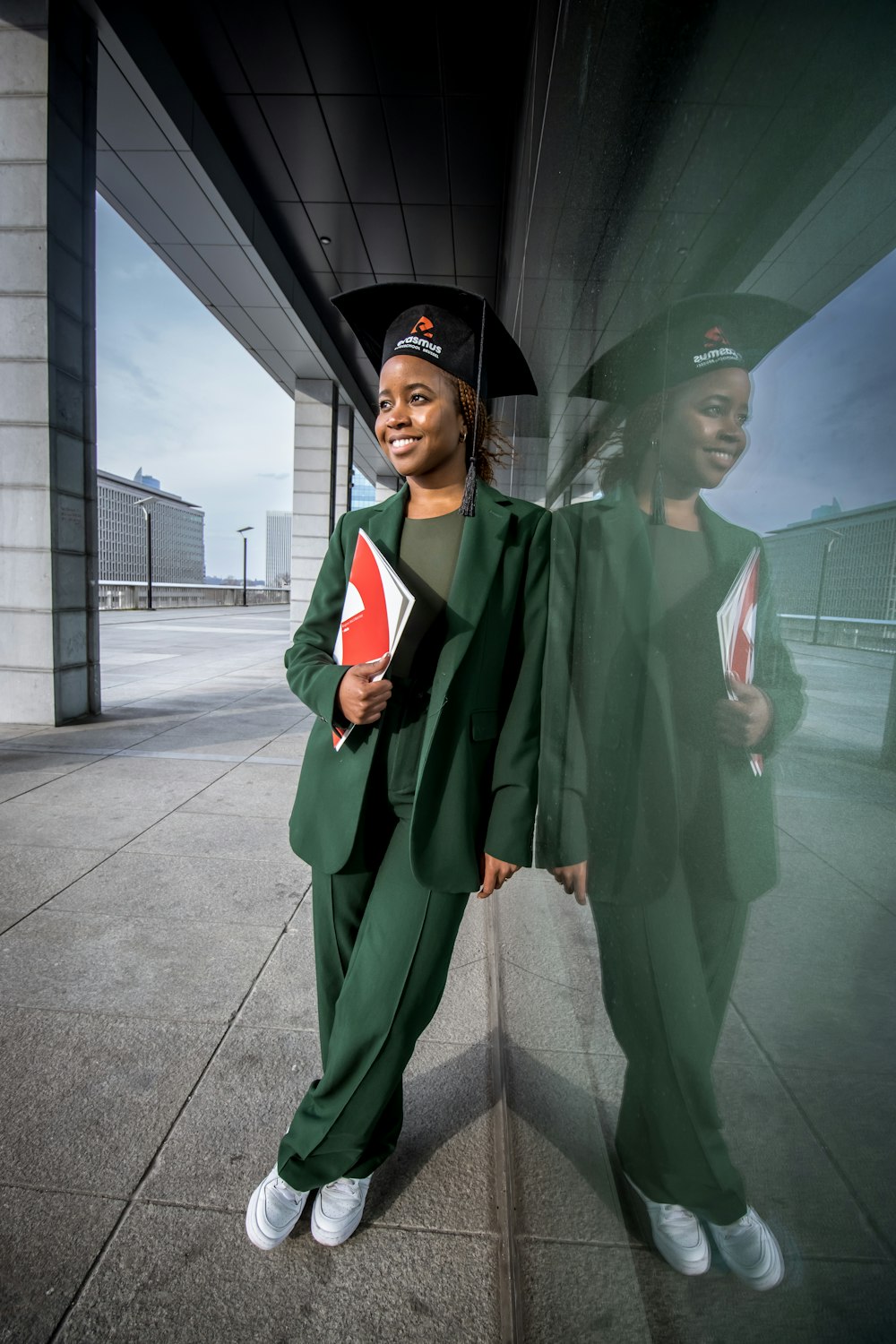 a woman in a graduation gown and cap holding a diploma